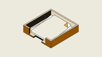A desk tray holding a few blank papers