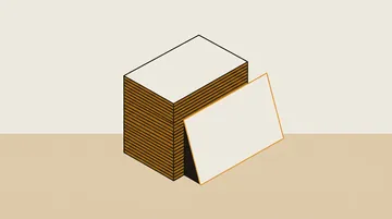 A side view of a stack of blank cards with one pulled out