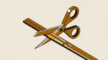 Scissors cutting through a plain flat cable