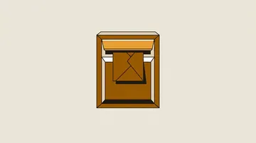 A letterbox with the flap shut and a blank envelope stuck in it